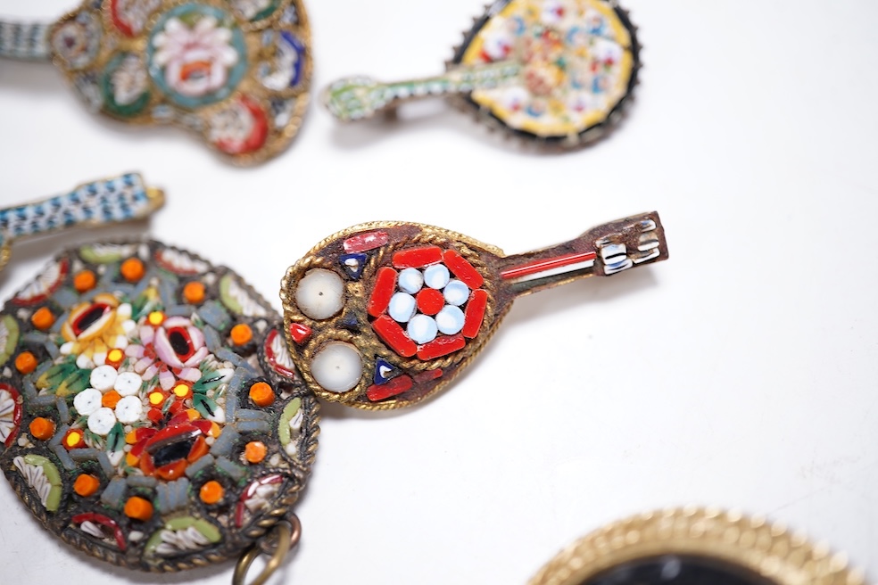 Thirty-one costume micro-mosaic brooches, to include seventeen guitar and banjo shaped brooches, five large oval/ circular brooches including scenic swan brooch, eight, smaller brooches and a pendant. Condition - fair/go